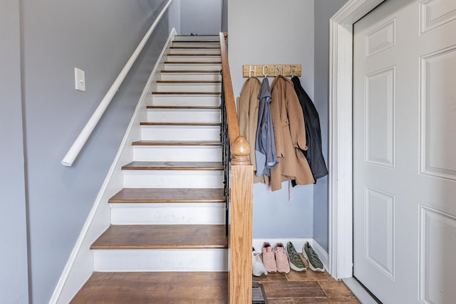 stairway featuring wood finished floors and baseboards