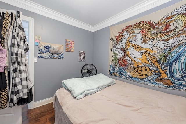 bedroom featuring dark wood-type flooring, crown molding, and baseboards
