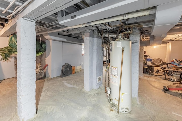 unfinished below grade area featuring water heater