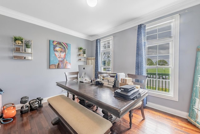 home office featuring baseboards, plenty of natural light, crown molding, and wood-type flooring