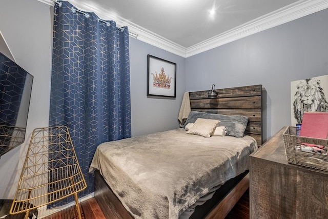 bedroom featuring crown molding and wood finished floors
