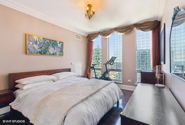 1400 S Michigan Ave Unit 2303, Chicago, IL 60605 - bedroom featuring ornamental molding, dark wood-type flooring, multiple windows, and baseboards