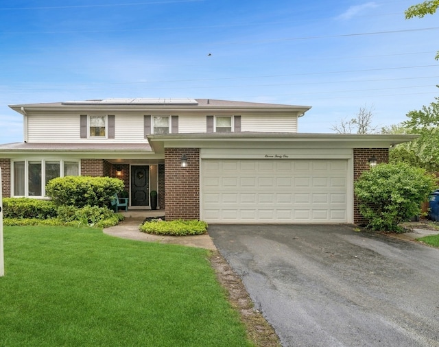 1131 New Trier Ct, Wilmette, IL 60091 - traditional home with brick siding, driveway, a front lawn, a garage, and roof mounted solar panels