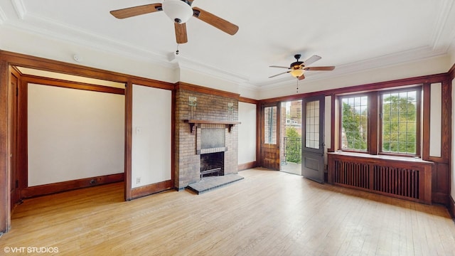 1366 E 57th St Unit 3, Chicago, IL 60637 - unfurnished living room with radiator heating unit, ceiling fan, wood finished floors, a brick fireplace, and ornamental molding