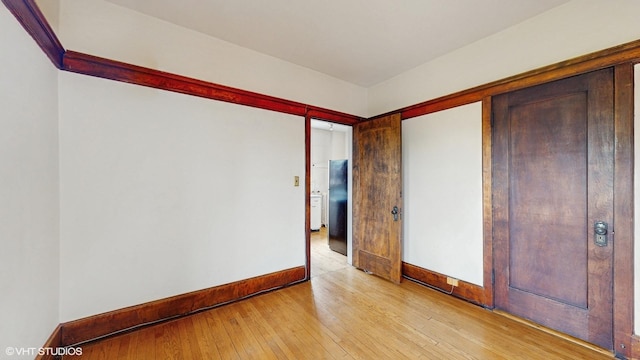 1366 E 57th St Unit 3, Chicago, IL 60637 - unfurnished bedroom with baseboards and light wood-style flooring