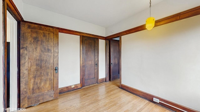 1366 E 57th St Unit 3, Chicago, IL 60637 - unfurnished bedroom with light wood-style floors and baseboards