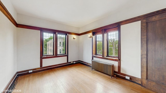 1366 E 57th St Unit 3, Chicago, IL 60637 - spare room featuring radiator, wood-type flooring, and baseboards