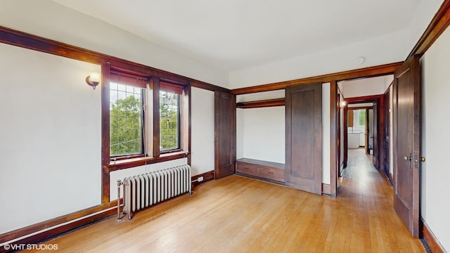 1366 E 57th St Unit 3, Chicago, IL 60637 - empty room featuring radiator heating unit, light wood-type flooring, and baseboards