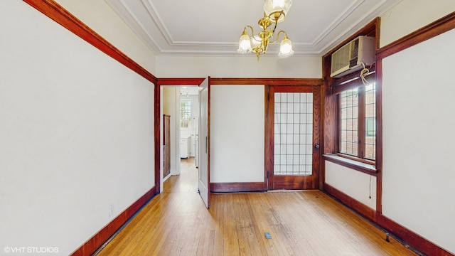 1366 E 57th St Unit 3, Chicago, IL 60637 - empty room featuring a wall mounted AC, a chandelier, hardwood / wood-style flooring, a tray ceiling, and baseboards