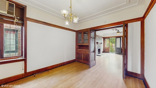 1366 E 57th St Unit 3, Chicago, IL 60637 - empty room featuring crown molding, a chandelier, light wood-style flooring, a brick fireplace, and baseboards