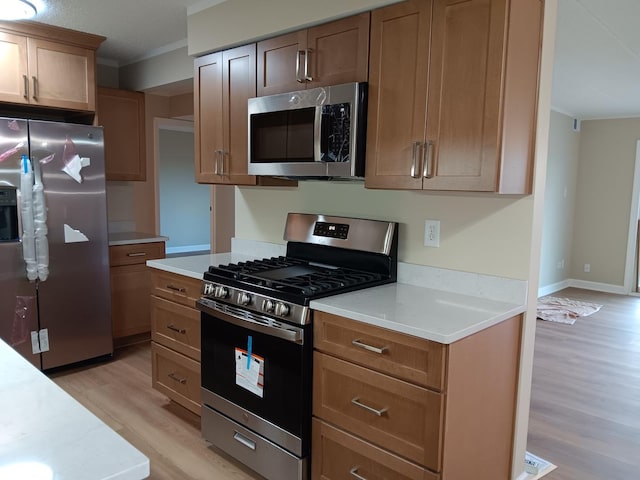 7537 175th St Unit 514, Tinley Park, IL 60477 - kitchen featuring stainless steel appliances, crown molding, light wood-style flooring, and light countertops