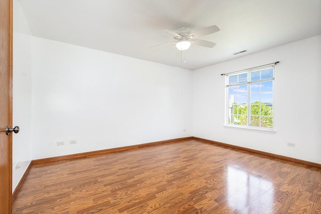 1376 Dahlgren Ln, Minooka, IL 60447 - empty room with wood finished floors, a ceiling fan, and baseboards