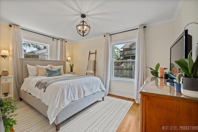 230 Union Ave, Batavia, IL 60510 - bedroom with a chandelier, light wood-type flooring, and crown molding