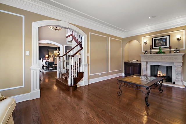 22388 Crimson Ln, Frankfort, IL 60423 - living room featuring arched walkways, a warm lit fireplace, stairs, a chandelier, and crown molding