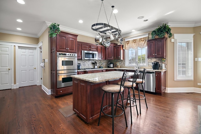 22388 Crimson Ln, Frankfort, IL 60423 - kitchen featuring appliances with stainless steel finishes, dark wood-style floors, a center island, decorative backsplash, and recessed lighting
