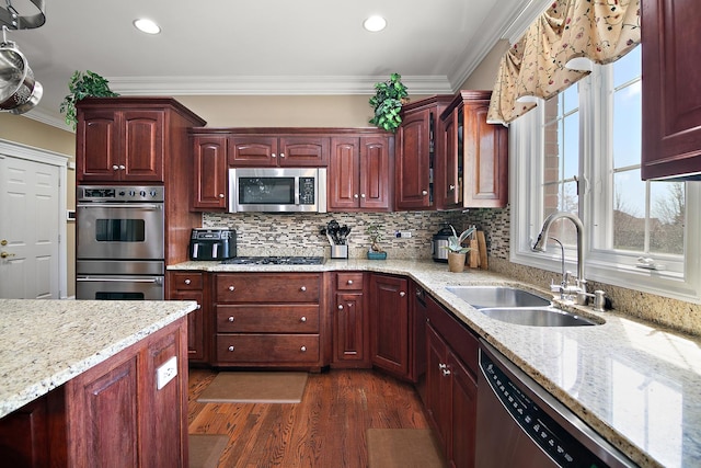 22388 Crimson Ln, Frankfort, IL 60423 - kitchen with stainless steel appliances, a sink, ornamental molding, dark brown cabinets, and dark wood-style flooring