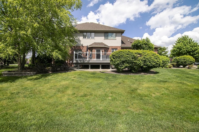 22388 Crimson Ln, Frankfort, IL 60423 - rear view of house featuring brick siding, a deck, a lawn, and roof with shingles