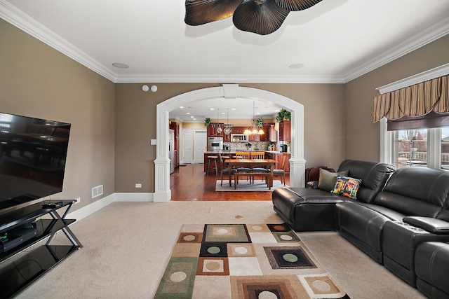 22388 Crimson Ln, Frankfort, IL 60423 - living area featuring arched walkways, crown molding, ceiling fan, light colored carpet, and baseboards
