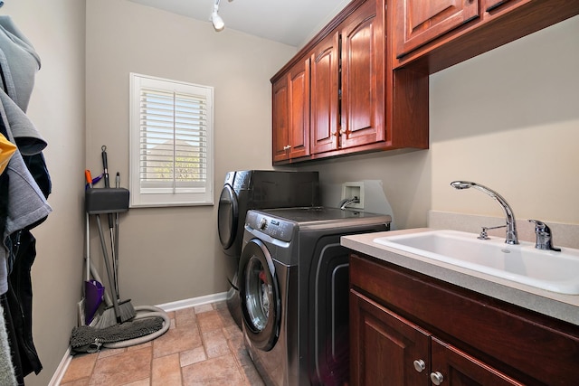 22388 Crimson Ln, Frankfort, IL 60423 - laundry room with washing machine and dryer, cabinet space, baseboards, and light stone finish flooring