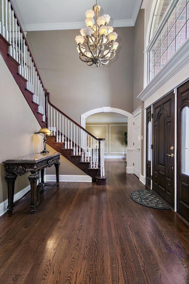 22388 Crimson Ln, Frankfort, IL 60423 - foyer entrance with arched walkways, a chandelier, stairs, a towering ceiling, and wood finished floors