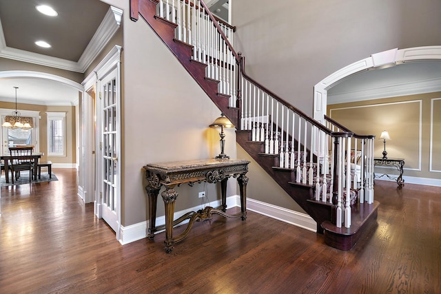 22388 Crimson Ln, Frankfort, IL 60423 - staircase with arched walkways, crown molding, wood finished floors, baseboards, and a chandelier