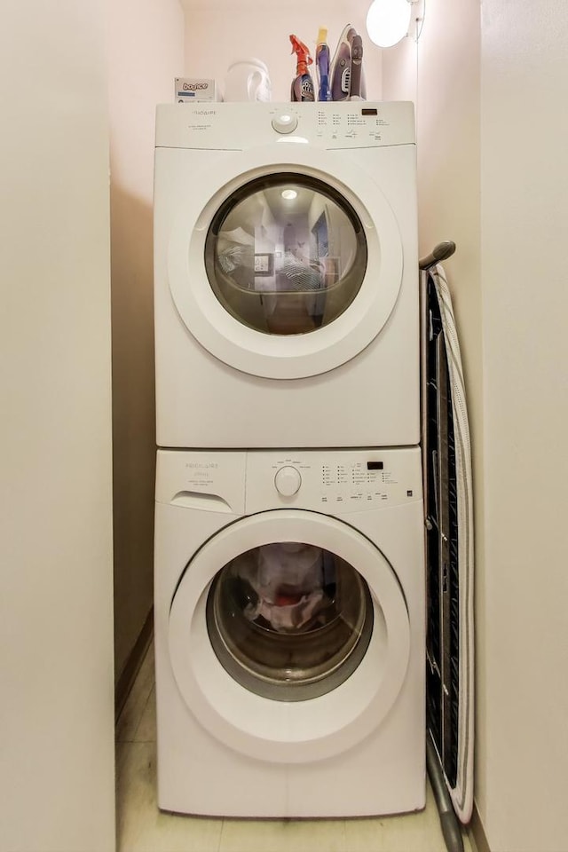 330 N Jefferson St Unit 903, Chicago, IL 60661 - laundry room with stacked washer and clothes dryer and light tile patterned floors