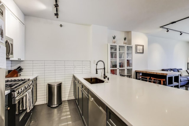 330 N Jefferson St Unit 903, Chicago, IL 60661 - kitchen featuring a sink, stainless steel appliances, rail lighting, light countertops, and open floor plan
