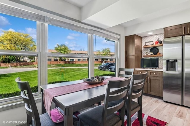 dining room with light wood-style flooring and recessed lighting