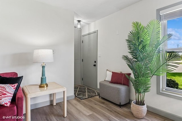 living area with wood finished floors and baseboards