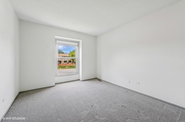 carpeted spare room with baseboards