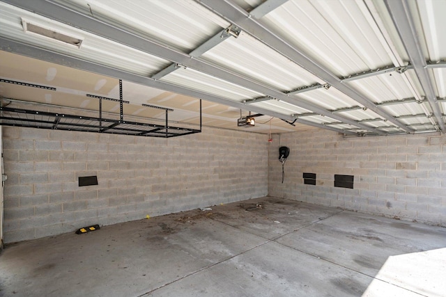 513 N Claremont Ave Unit 3S, Chicago, IL 60612 - garage featuring a garage door opener and concrete block wall
