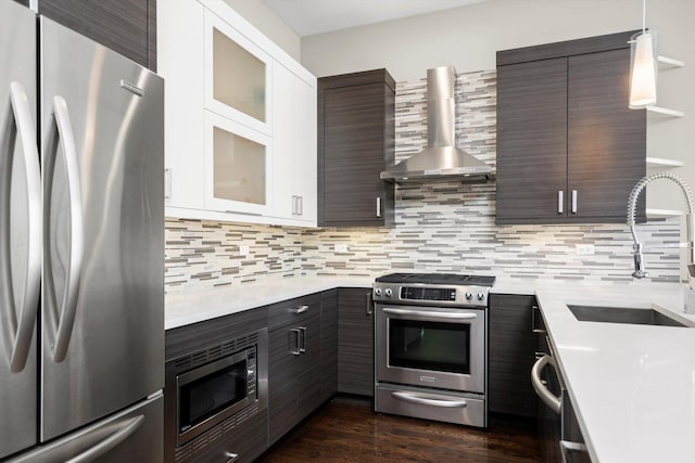 513 N Claremont Ave Unit 3S, Chicago, IL 60612 - kitchen with stainless steel appliances, wall chimney exhaust hood, dark brown cabinetry, light countertops, and a sink
