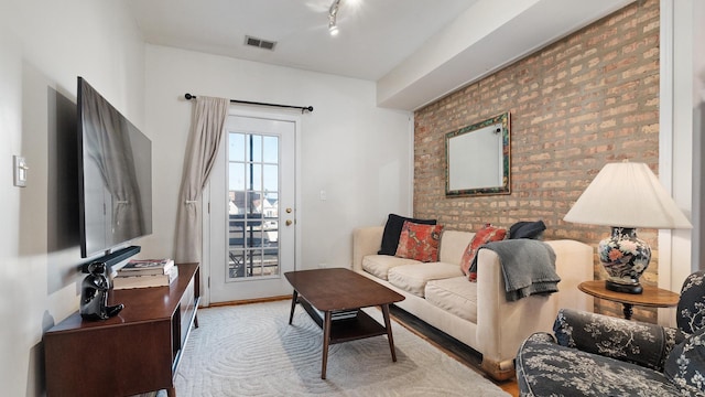 2544 W George St Unit 2, Chicago, IL 60618 - living area featuring wood finished floors, brick wall, and rail lighting