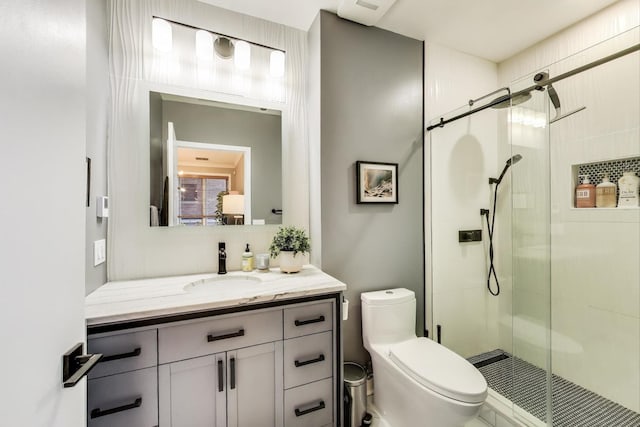 full bathroom with a shower stall, toilet, and vanity