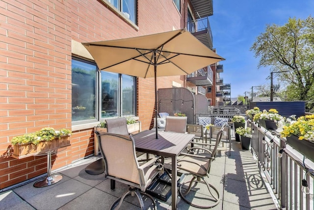 view of patio featuring outdoor dining area and fence