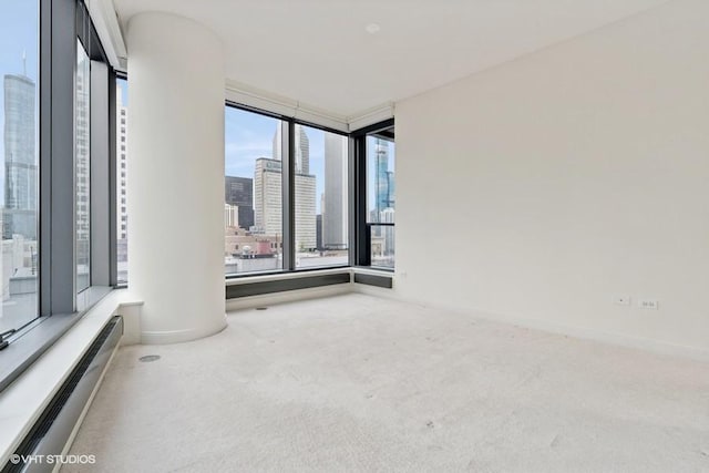 60 E Monroe St Unit 2607, Chicago, IL 60603 - empty room with a baseboard radiator, carpet flooring, a view of city, and baseboards