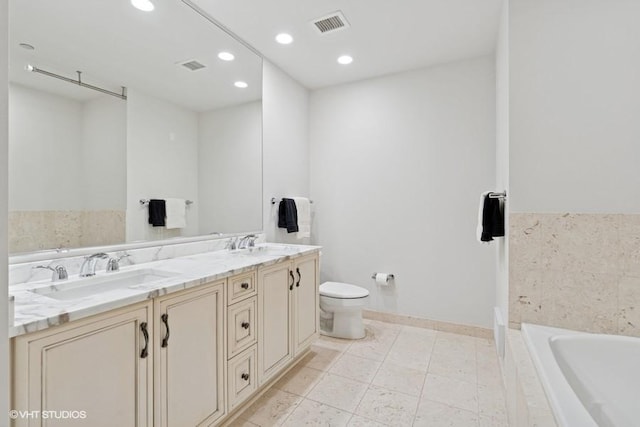 60 E Monroe St Unit 2607, Chicago, IL 60603 - bathroom featuring a garden tub, double vanity, toilet, recessed lighting, and baseboards