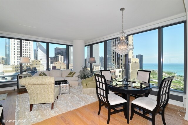 60 E Monroe St Unit 2607, Chicago, IL 60603 - dining room with wood finished floors, a chandelier, a city view, and healthy amount of natural light