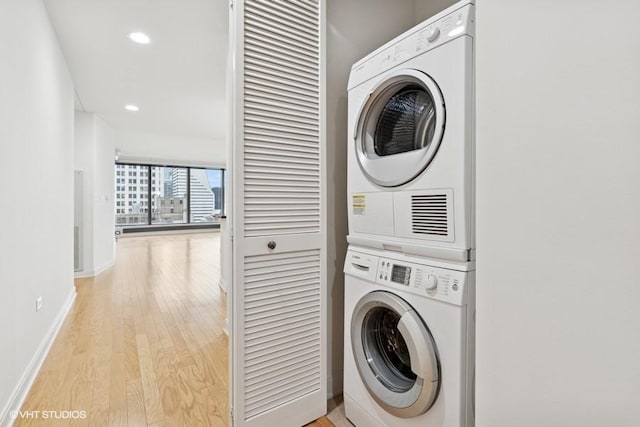 60 E Monroe St Unit 2607, Chicago, IL 60603 - washroom featuring estacked washer and dryer, light wood-type flooring, baseboards, and recessed lighting