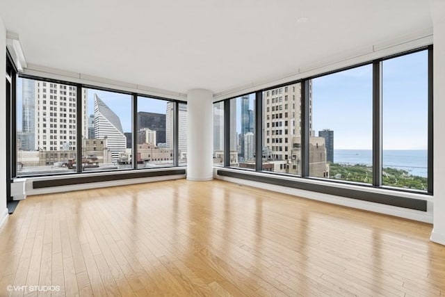 60 E Monroe St Unit 2607, Chicago, IL 60603 - unfurnished room with a city view, wood finished floors, and a water view