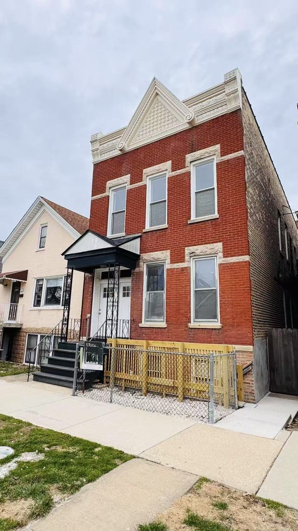 3621 S Winchester Ave, Chicago, IL 60609 - view of property with brick siding and a fenced front yard