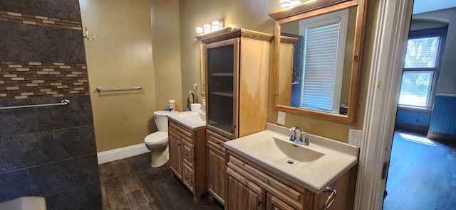 full bath with wood finished floors, toilet, vanity, and baseboards
