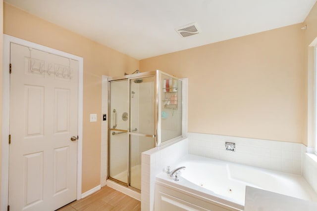 31 Jefferson Ln, Streamwood, IL 60107 - full bath with a shower stall, a jetted tub, and wood finished floors