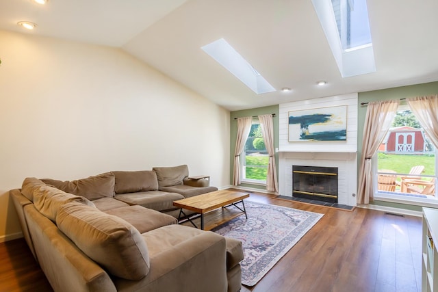 31 Jefferson Ln, Streamwood, IL 60107 - living area featuring a skylight, vaulted ceiling, a brick fireplace, dark wood-type flooring, and recessed lighting