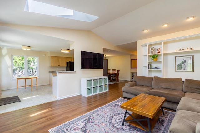 31 Jefferson Ln, Streamwood, IL 60107 - living room with lofted ceiling, light wood-style floors, a skylight, and baseboards