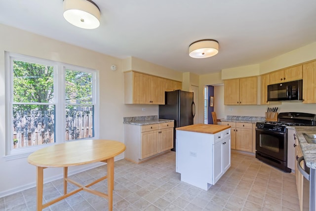 31 Jefferson Ln, Streamwood, IL 60107 - kitchen featuring black appliances, butcher block countertops, light brown cabinetry, a center island, and baseboards