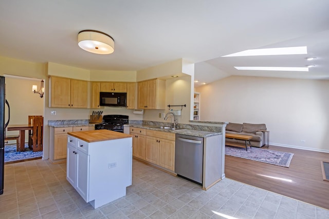 31 Jefferson Ln, Streamwood, IL 60107 - kitchen featuring black appliances, light brown cabinetry, a sink, a skylight, and vaulted ceiling