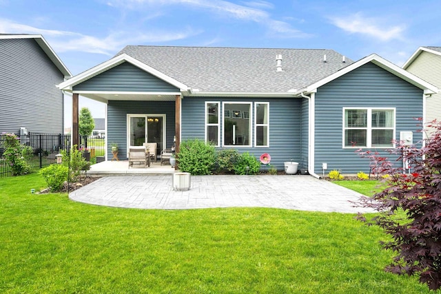 back of property featuring a patio area and a shingled roof