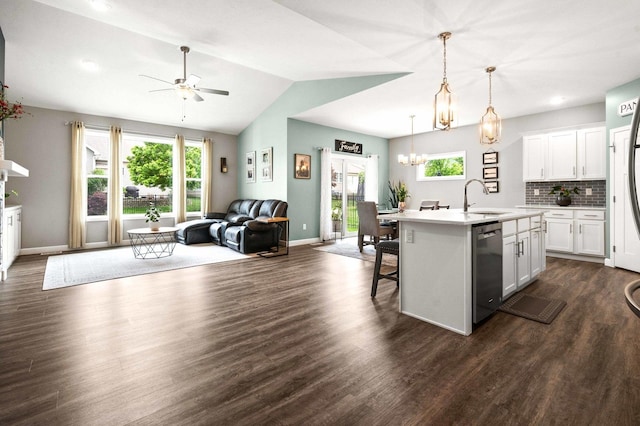 kitchen with dishwasher, a sink, open floor plan, light countertops, and healthy amount of natural light