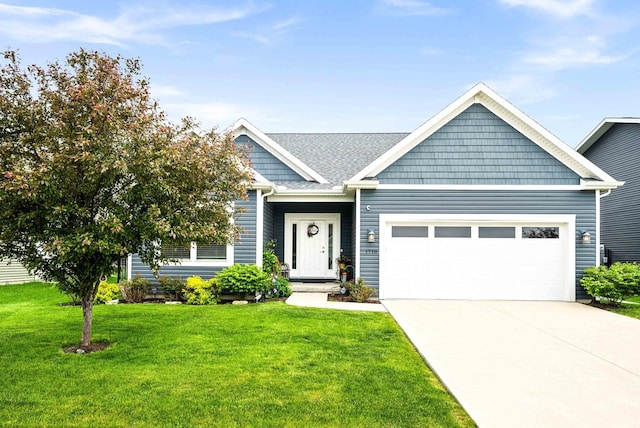 craftsman inspired home with an attached garage, concrete driveway, and a front lawn